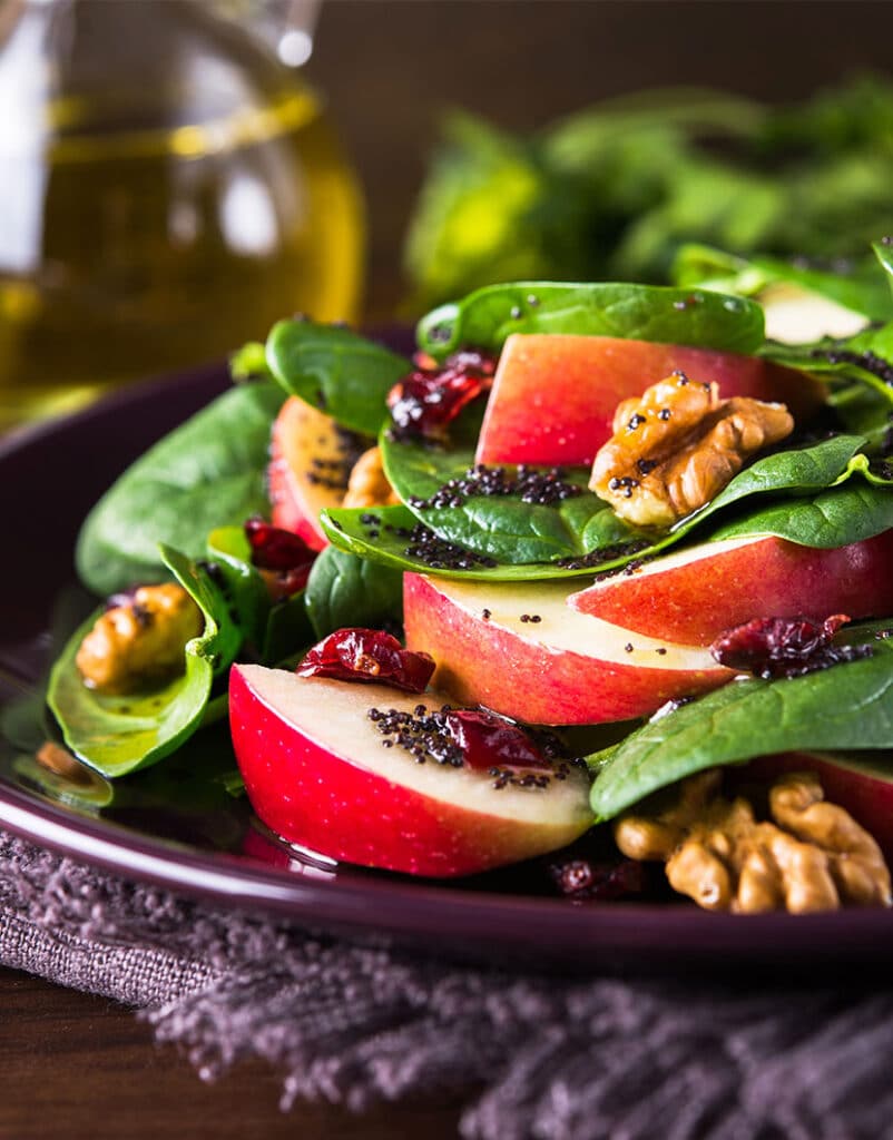 closeup of salad with walnuts and apples